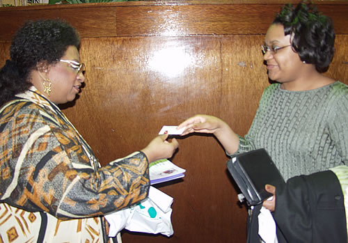Sister handing Sister business card, Detroit, Michigan Black Business Seminar