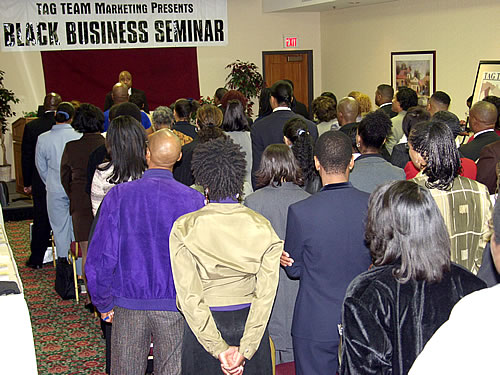Delxino leading audience through exercise, Los Angeles, California Black Business Seminar