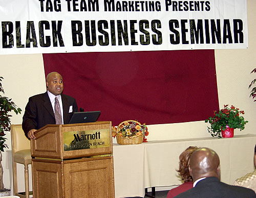 Delxino speaking to the audience, Los Angeles, California Black Business Seminar