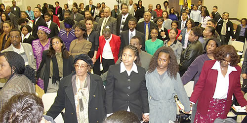 Audience holding hands, College Park, Maryland Black Business Seminar