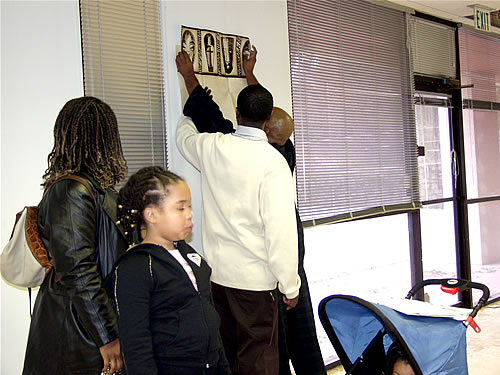 Delxino showing TAG TEAM members the wallpaper for the reception area, Construction Tour of Atlanta TAG TEAM Marketing Center