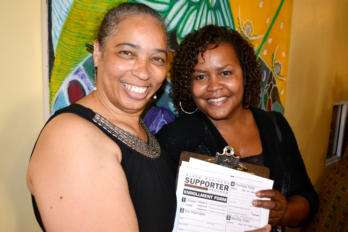 Dorothy signing up a new Supporter at event, 2015 Buy Black Movement Los Angeles Launch
