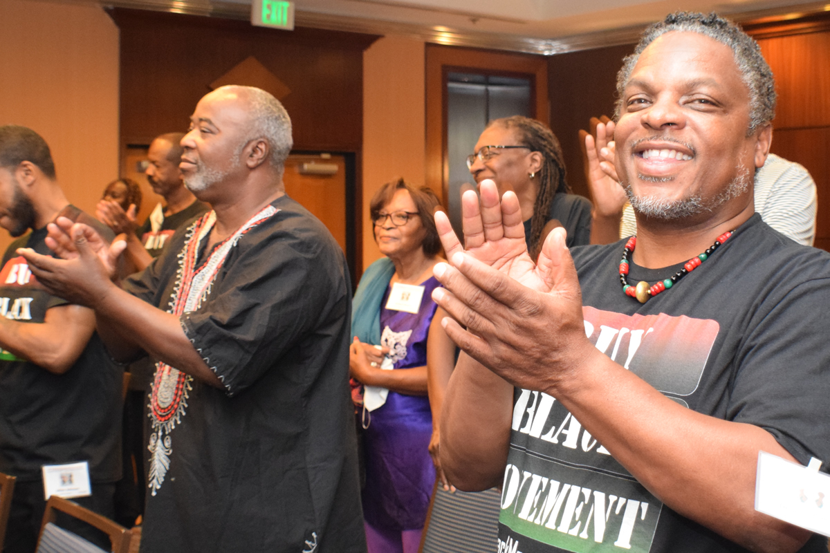 Dennis and audience clapping for speaker, 2019 TAG TEAM Convention - Los Angeles, California