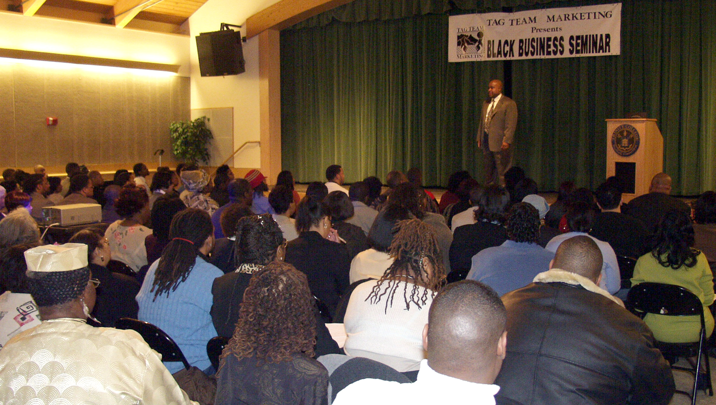 Delxino speaking to audience at Black Business Seminar